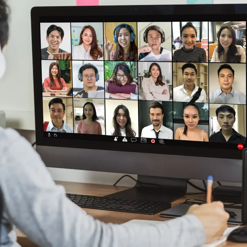 Rear view of Asian businessman working and online meeting via video conference with colleague